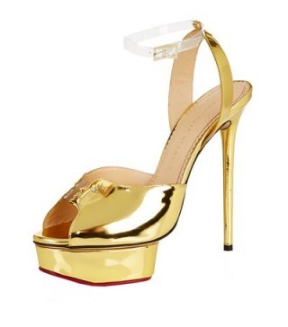 These glamorous gold leather platform sandals from Charlotte Olympia were worn by Elle Fanning on the The Tonight Show with Jimmy Fallon, 1 September 2015. Available from harrods.com & selfridges.com. Celebrity fashion | star style | designer shoes | glamour - flipped