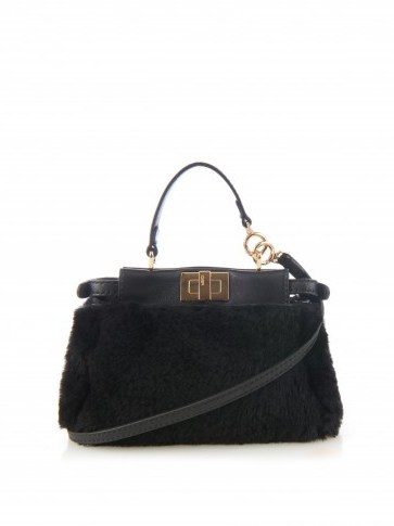 FENDI Micro Peekaboo shearling cross-body bag in black. Designer handbags | luxury bags | small shoulder bags - flipped