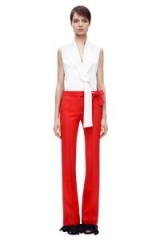 Victoria Beckham Flare Trouser red – as worn by Victoria Beckham at Lax airport, 26 October 2015. Celebrity fashion | star style | what celebrities wear | designer trousers
