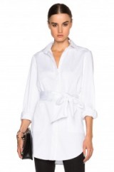 SALLY LAPOINTE STRETCH COTTON OVERSIZED SHIRT WITH WRAP BELT in white. Casual chic | elegant style | designer shirts