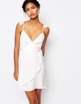 Wyldr Wrap Front Tea Dress with Frills in white. Low cut | plunge front | plunging party dresses | going out | evening fashion