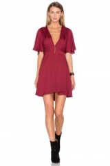 HOUSE OF HARLOW 1960 X REVOLVE HARPER WRAP DRESS in oxblood. Dark red dresses | plunge front fashion | flared ruffle short sleeves | silky fabric | deep V neckline | plunging necklines