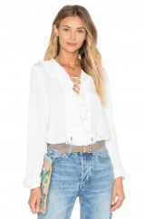 L’ACADEMIE THE RUFFLE BOHO BLOUSE ivory – from Olivia Palermo’s Hampton’s must-have’s, July 2016. Celebrity style blouses | ruffles shirts | summer tops | star style fashion | lace up front | Olivia Palermo style