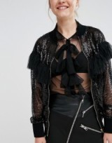 Sister Jane Sequin Ruffle Bomber Jacket black. Embellished jackets | semi sheer outerwear | sequins | ruffles | casual glamour