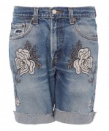 BLISS AND MISCHIEF LIGHT WASH DENIM SHADOW FLOWER EMBROIDERED SHORTS. Blue denim | floral embroidery | cut offs