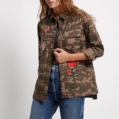 River Island Brown camo badge shacket. On trend womens shackets | shirt/jacket tops | trending fashion | lightweight jackets | casual clothing trends | camouflage print | heavier shirts - flipped