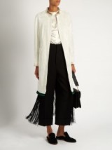 TOGA Fringe-trimmed velvet coat in white with long black fringing. Statement coats | designer outerwear | luxe Autumn fashion | chic clothing