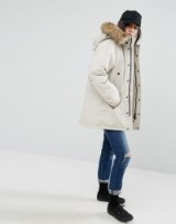 Carhartt WIP Oversized Anchorage Hooded Parka Jacket With Removable Faux Fur in Cream. On trend winter jackets | fashionable parkas | warm coats | weekend outerwear