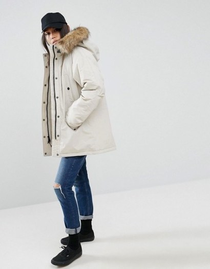 Carhartt WIP Oversized Anchorage Hooded Parka Jacket With Removable Faux Fur in Cream. On trend winter jackets | fashionable parkas | warm coats | weekend outerwear - flipped