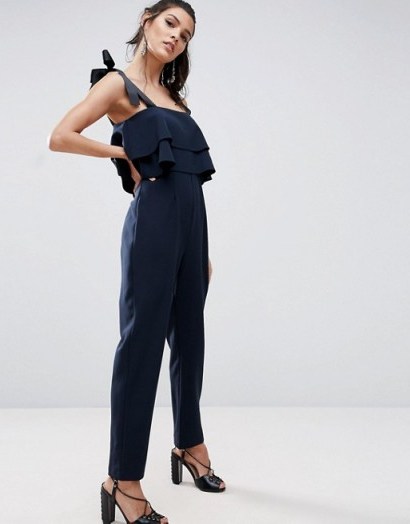 ASOS Jumpsuit with Double Ruffle and Contrast Grosgrain Tie in navy blue. Jumpsuits with style | on-trend fashion - flipped