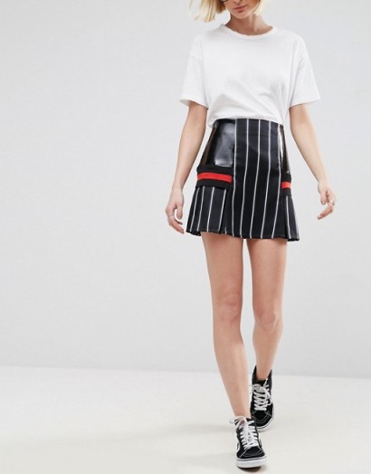 Jade Thirwall wore a black ASOS WHITE Pinstripe Skirt With Contrast Panels and a black ribbed funnel neck top, while attending the evian Live Young suite during Wimbledon 2017 at the All England Tennis and Croquet Club, 3 July 2017. Celebrity mini skirts | star style fashion