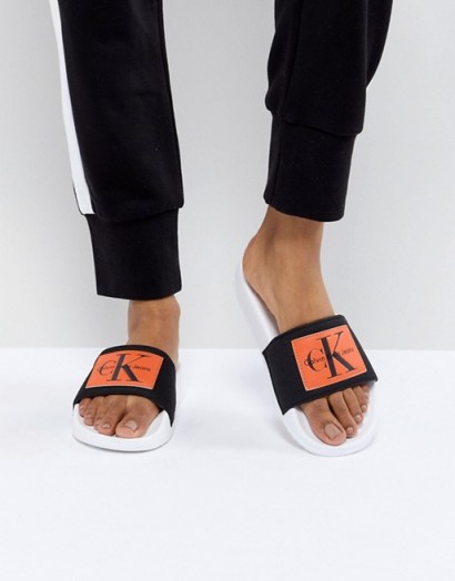 Calvin Klein Chloe Black and Orange Sliders | designer footbed slides