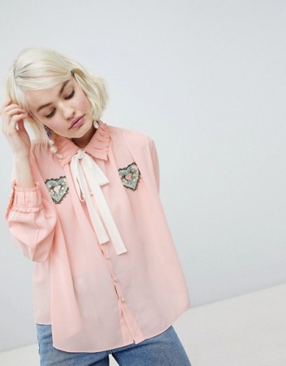 Sister Jane blouse with ribbon tie and heart patch detail in peach – vintage look fashion - flipped