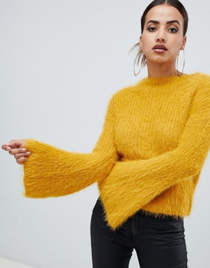 PrettyLittleThing flared sleeve fluffy jumper in yellow | wide sleeved sweater