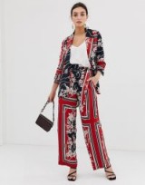 River Island wide leg trousers in scarf print in red. FLORAL AND STRIPE PRINTS