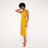 WAREHOUSE OPEN BACK CULOTTE JUMPSUIT IN YELLOW / colours for spring fashion