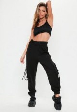 Missguided black seat belt jersey cargo trousers | strap detail pants