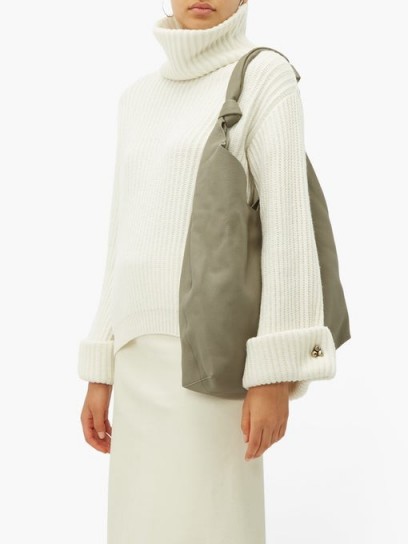 BRUNELLO CUCINELLI Faceted buttoned-cuff cashmere roll-neck sweater in cream | luxury roll neck sweaters