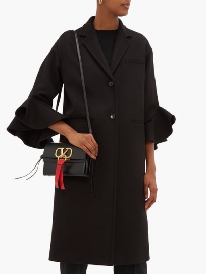 VALENTINO Ruffled-cuff single-breasted wool-blend coat in black ~ chic winter coats