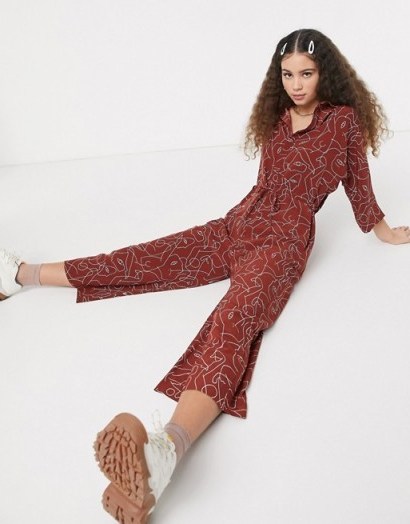 Monki Harriot face print wide leg jumpsuit in rust – abstract printed jumpsuits - flipped