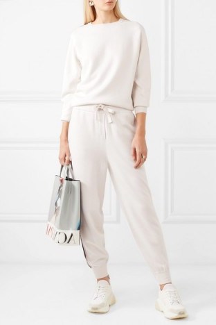 Jennifer Lopez white side stripe tracksuit, OLIVIA VON HALLE Missy Moscow striped silk and cashmere-blend sweatshirt and track pants set, out in Miami, 23 February 2020 | casual celebrity fashion - flipped