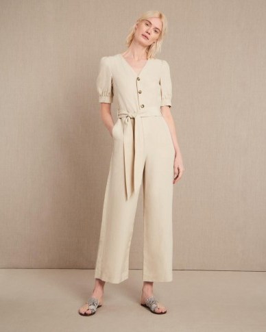 VOLUME SLEEVE JUMPSUIT – Jaeger – A lightweight and breathable option in a neutral colour, this jumpsuit is a timeless choice with a flattering cinched waist and playful voluminous sleeves. The V-neckline lends sophistication while the buttons down the front add texture and detail to the unfussy finish. - flipped
