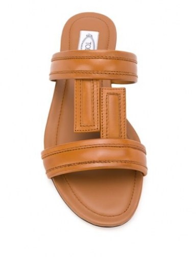 In the style of Olivia Culpo’s brown and cream flats on Instagram, Tod’s flat leather sandals in brown, 23 July 2020 | celebrity social media footwear