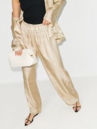Hailey Bieber cream printed trousers, Totême Vizelle Monogram Silk Trousers, worn on Instagram, 29 July 2020 | celebrity social media style