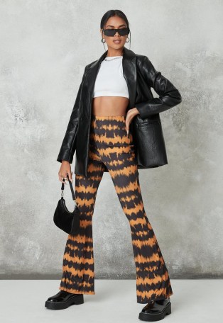 MISSGUIDED orange tie dye ribbed jersey flare trousers / printed flares
