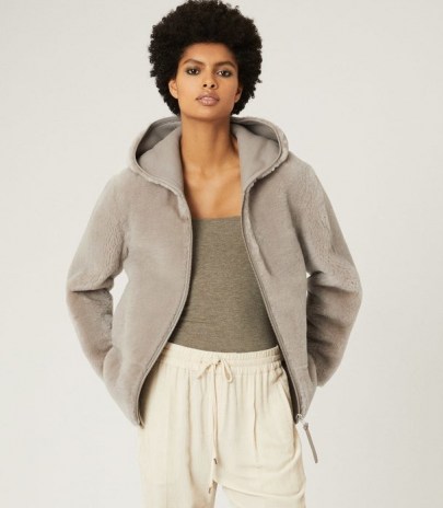 Reiss AMELIA REVERSIBLE SHEARLING HOODED COAT PALE GREY – casual luxe coats – luxury front zip jackets - flipped