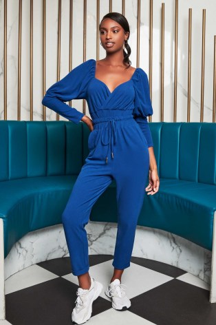 patricia bright puff sleeve jogger jumpsuit in blue / jumpsuits / celebrity fashion collarborations - flipped
