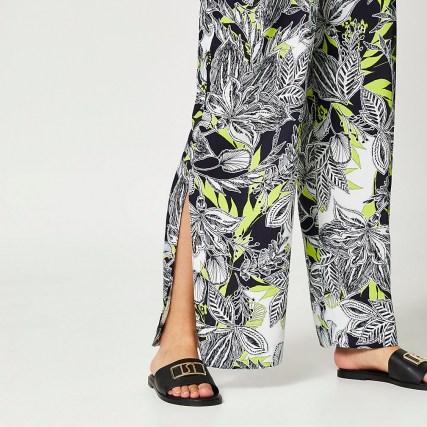 RIVER ISLAND Black floral print pleated wide leg trousers / side split hem pants - flipped