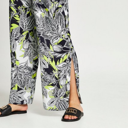 RIVER ISLAND Black floral print pleated wide leg trousers / side split hem pants