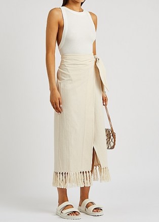NANUSHKA Randi cream tasselled cotton wrap skirt – asymmetric side tie summer skirts with fringed hem