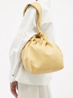 JIL SANDER Drawstring-top medium cream leather clutch / womens slouchy bags - flipped
