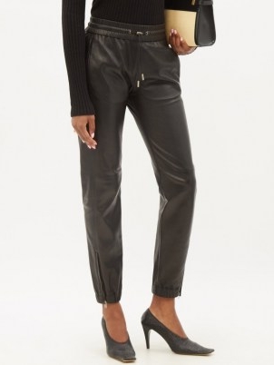SAINT LAURENT Zip-cuff black leather trousers ~ womens sportswear inspired trousers ~ women’s luxury style joggers ~ sports luxe jogger pants