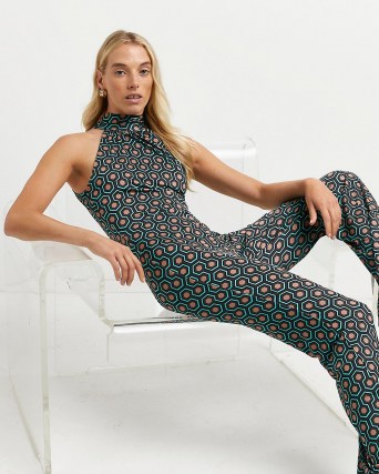 River Island Green geometric print jumpsuit | retro geo print jumpsuits | halterneck going out fashion | halter neck fitted all-in-one