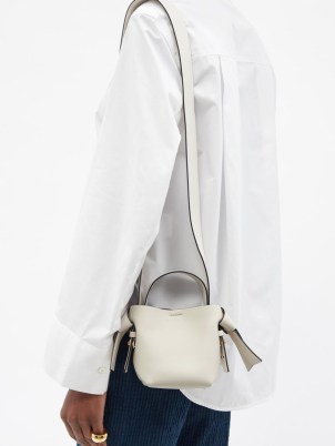 ACNE STUDIOS Musubi micro white leather cross-body bag – cute mini shoulder bags – small top handle crossbody – knotted strap detail handbags
