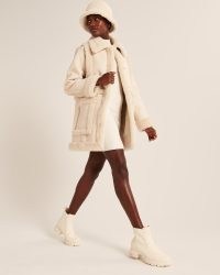 ABERCROMBIE & FITCH Oversized Sherpa-Lined Vegan Leather Coat in Cream / luxe style faux shearing trimmed coats / womens on-trend winter outerwear