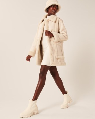 ABERCROMBIE & FITCH Oversized Sherpa-Lined Vegan Leather Coat in Cream / luxe style faux shearing trimmed coats / womens on-trend winter outerwear - flipped