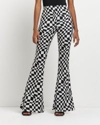 River Island BLACK CHECKERBOARD FLARED TROUSERS | women’s funky retro flares