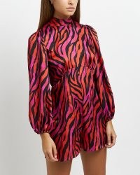 River Island RED ANIMAL PRINT PLAYSUIT – long sleeved high neck playsuits – open tie back detail