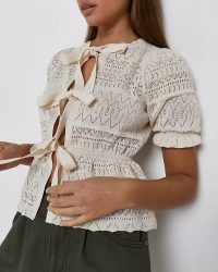 Knitted puff sleeved peplum top | River Island ECRU TIE FRONT KNIT TOP | feminine knits