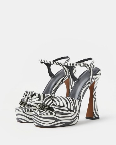 Monochrome animal print platforms | black and white printed platform sandals | glamorous retro shoes | 70s inspired knot detail high heels