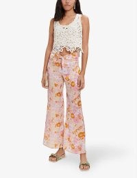 MAJE Flower Power floral-print flared mid-rise recycled-polyester trousers – retro flower prints – vintage style tie up waist flares