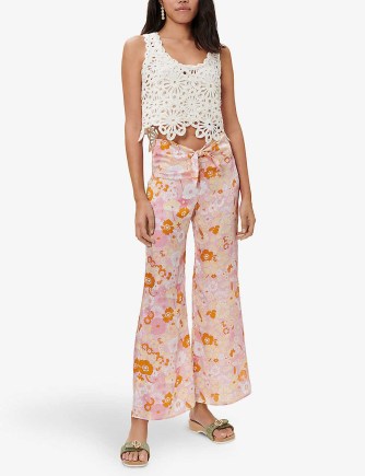 MAJE Flower Power floral-print flared mid-rise recycled-polyester trousers – retro flower prints – vintage style tie up waist flares - flipped