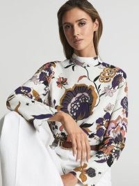 REISS ANNIE RETRO PRINT BLOUSE – chic long sleeve high neck blouses – relaxed shift silhouette tops – womens clothes with bold floral prints – add white flares and a pair of strappy wedges for a chic 70s inspired summer look