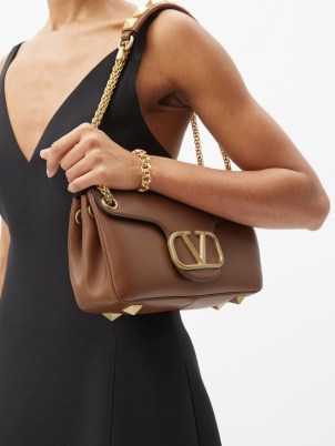 VALENTINO GARAVANI Stud Sign leather shoulder bag ~ tan studded designer bags ~ luxury brown handbags with gold shoulder chain ~ MATCHESFASHION - flipped