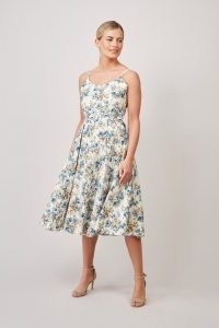 The Pretty Dress Company – PRISCILLA DARLING ROSE MIDI DRESS – Fully lined with cotton lining with slight stretch for comfort – Bias cut bodice with slight stretch – Adjustable straps – Signature midi circle skirt with pleats and pockets – Concealed centre back zip