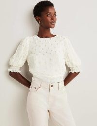 Boden Cropped Metallic Smocked Top Ivory and Gold Clip / women’s short puff sleeved textured spot tops / feminine smock detail hem and cuffs / dobby effect fabric